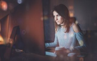 A woman looking at a computer screen